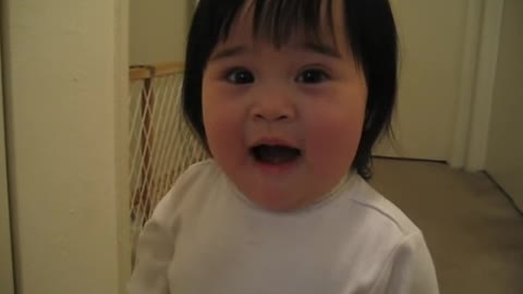 Adorable Asian Girl Trying to Saying "Frog"