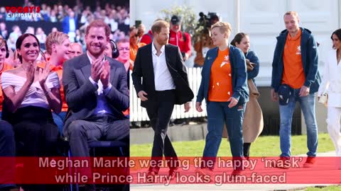 Meghan Markle in the 'happy mask’ while Prince Harry looks glum-faced