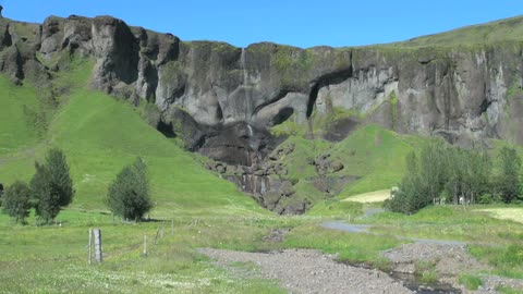 Iceland south cliffs with small waterfall