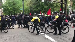 May 1 2017 Portland may day 1.3 Antifa marching, one has a slingshot and used it