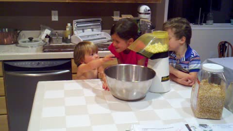 Excited toddler goes nuts for popcorn machine