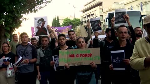 Iranians in Greece cut hair, burn headscarf in protest