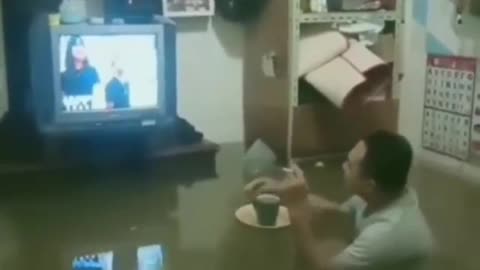 Watching TV while drinking coffee during the flood