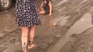 Girl slipping on mud and falling down