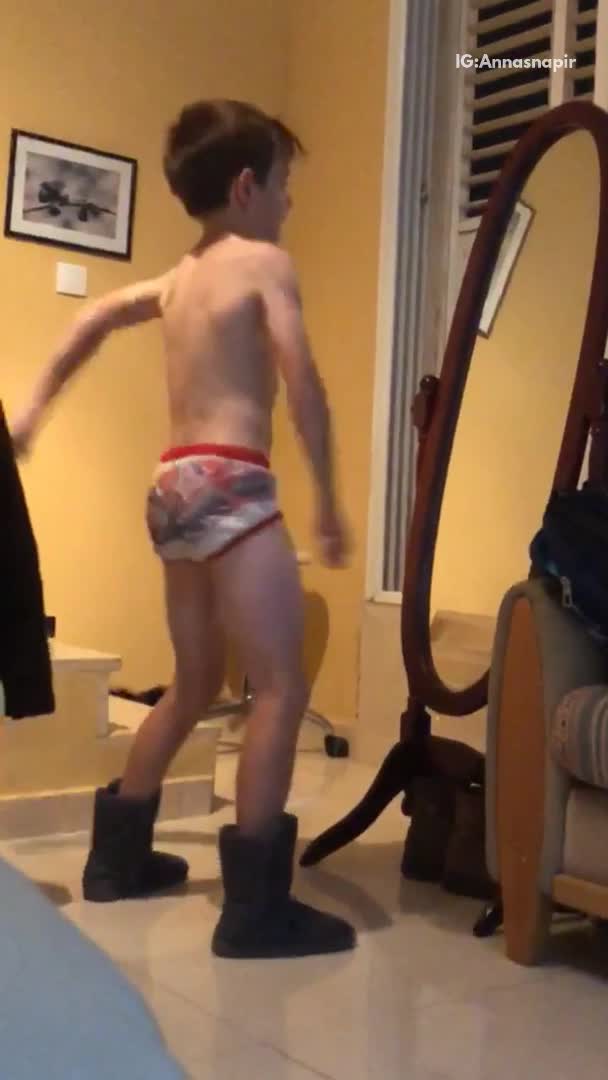 Kid dancing in ugg boots and underwear infront of mirror