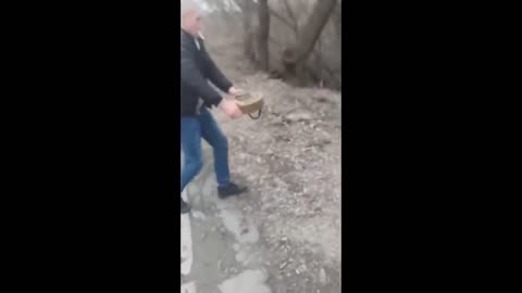 RUSSIAN WAR IN UKRAINE - UKRAINIAN CIVILIAN REMOVES LANDMINE FROM ROAD WITHOUT ANY FEAR