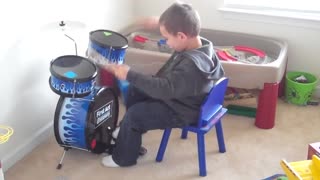 Isaiah playing his drums