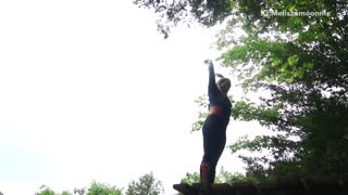 Girl backflip off platform into lake belly flop