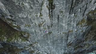 Group of Climbers Scale Cliffside