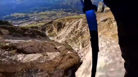 Extreme paraglider shuttling through the valley