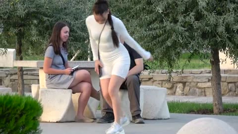 A girl asks a boy for a massage of her in front of their companions