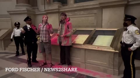 Climate Activists Dump Red Powder On Constitution Display At The National Archives