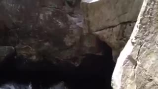 Guy slips on rock falls in lake