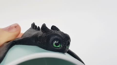 Night Fury Toothless Rayeye How to Train Your Dragon sit on a menthol cup with border by AnneAlArt