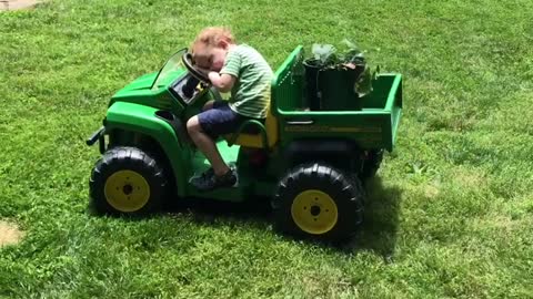 Kid literally falls asleep while driving tractor
