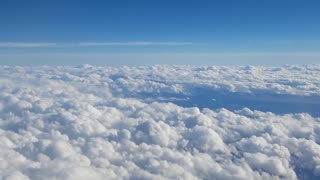 Plain fly over the clouds view from above