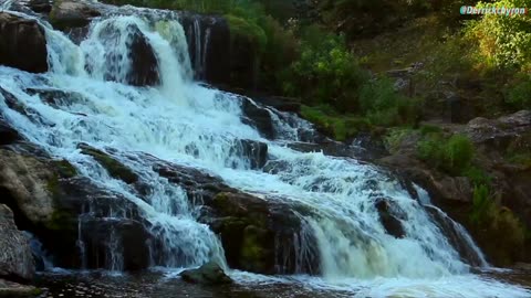 Finding Calm In A Magnificent Cascade Waterfall In The Woods With A Beautiful Landscape.