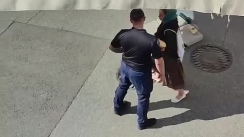 While the woman was distracting the Kiev regime's policeman, the Orthodox priest threw bread