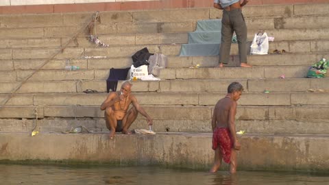Man Brushing His Teeth on a Ganges Ghat