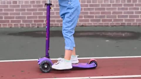 girl riding a kick scooter