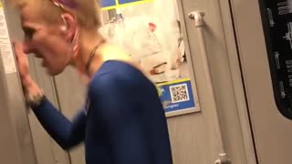 Woman blue jump suite dancing on train