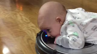 Baby Adorably Rides On "Roomba"