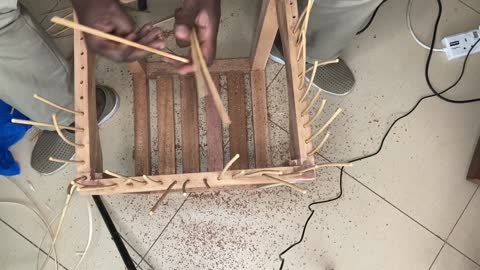 Rattan weaving on wood.