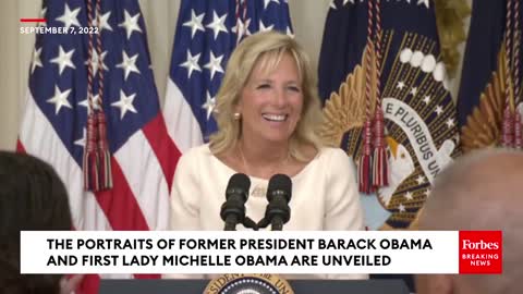 Joe Biden sits during a standing ovation, Jill points it out