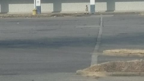 Child Chases Car Through Abandoned Carpark