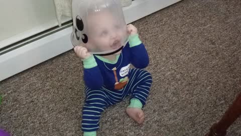 Baby hilariously puts toy bucket on head