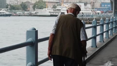 Old man walking alone at river bank