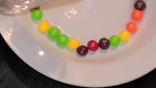 added BOILING water to a plate of SKITTLES!!.... YOU WON'T BELIEVE WHAT HAPPENED NEXT. MUST WATCH!