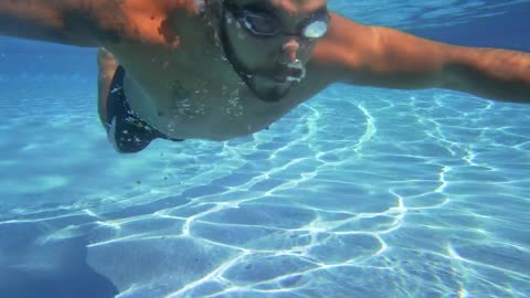 Swimming underwater in a pool