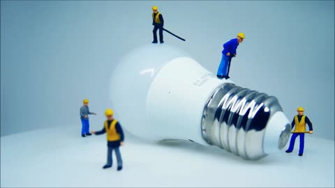 Close-up View Of A Lightbulb And Miniature Toys 1