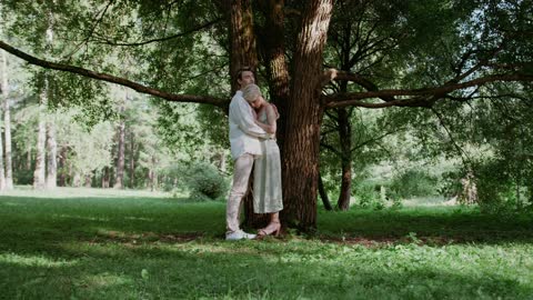 Couple Hugging Each Other Under the Tree