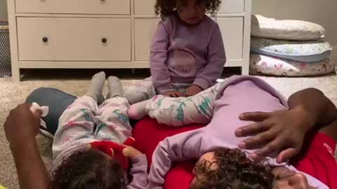 Little Girls Squabble Over Place To Cuddle With Daddy