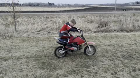 Kid trying to kickstart start dirt bike