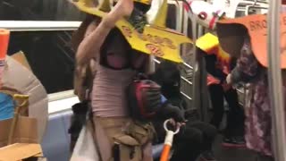 Guys in different costumes dancing on subway