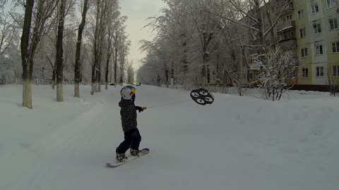 Snowboarding Toddler In Russia Uses Flying Drone To Move Around His Neighborhood