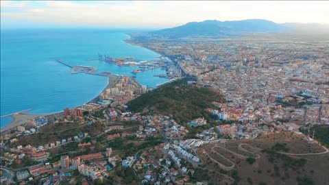 malaga spain a panorama shot by a drone over malaga city buildings and seaside view ships and port