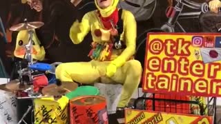 Chicken outfit man playing drums