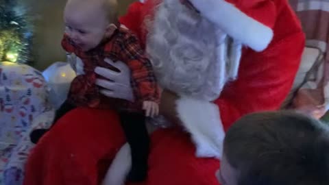 Baby meets Santa for the first time