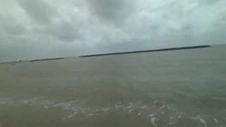 Filming the coast of the sea, you can see buildings and rocks [Nature & Animals]