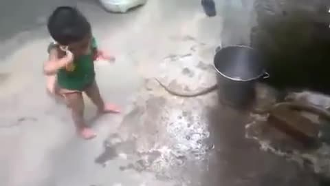 2 year baby playing with SNAKE