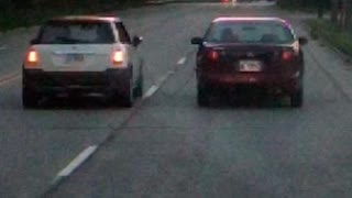 Two Cars Drive Together with Jumper Cable Attached