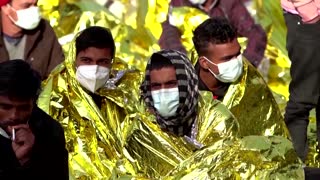Migrants sleep on Lampedusa road before quarantine