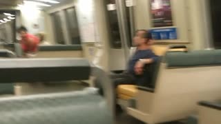 Person rides scooter through subway train speed lime