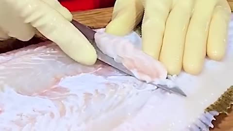 Cutting and cleaning of fish in restaurant