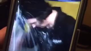 Guy black shirt opening beer with head and spilling it everywhere