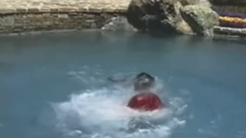 Macaulay Culkin pushes Michael Jackson off diving board, 1989